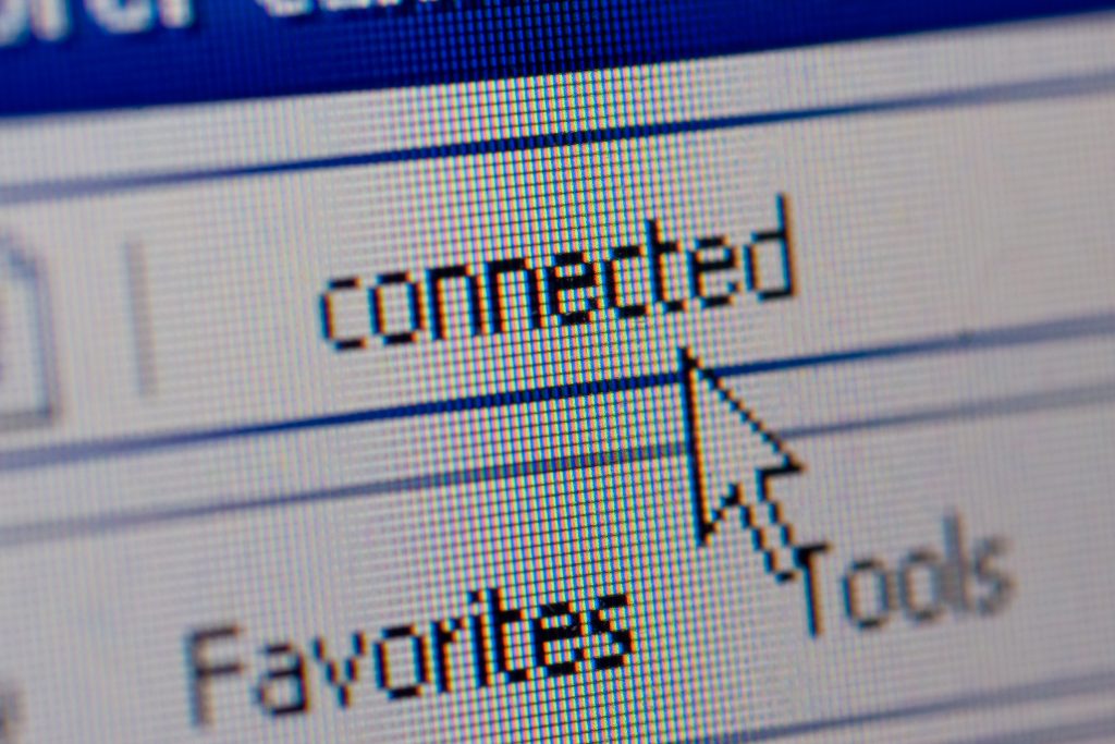 A close-up image reveals a computer screen with the word "connected" in a pixelated design, reminiscent of Jane's digital artistry. The cursor arrow points at it, indicating a successful network connection. Below, the toolbar displays "Favorites" and "Tools," enhancing the screen's functionality.