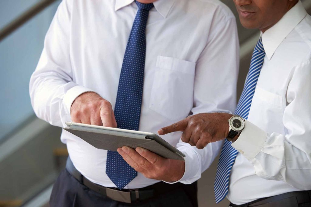 Business people analyzing report on tablet