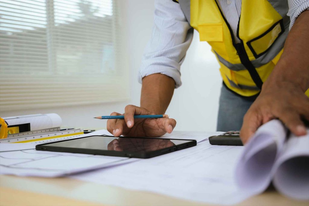 closeup of construction worker reviewing paperwork and permits